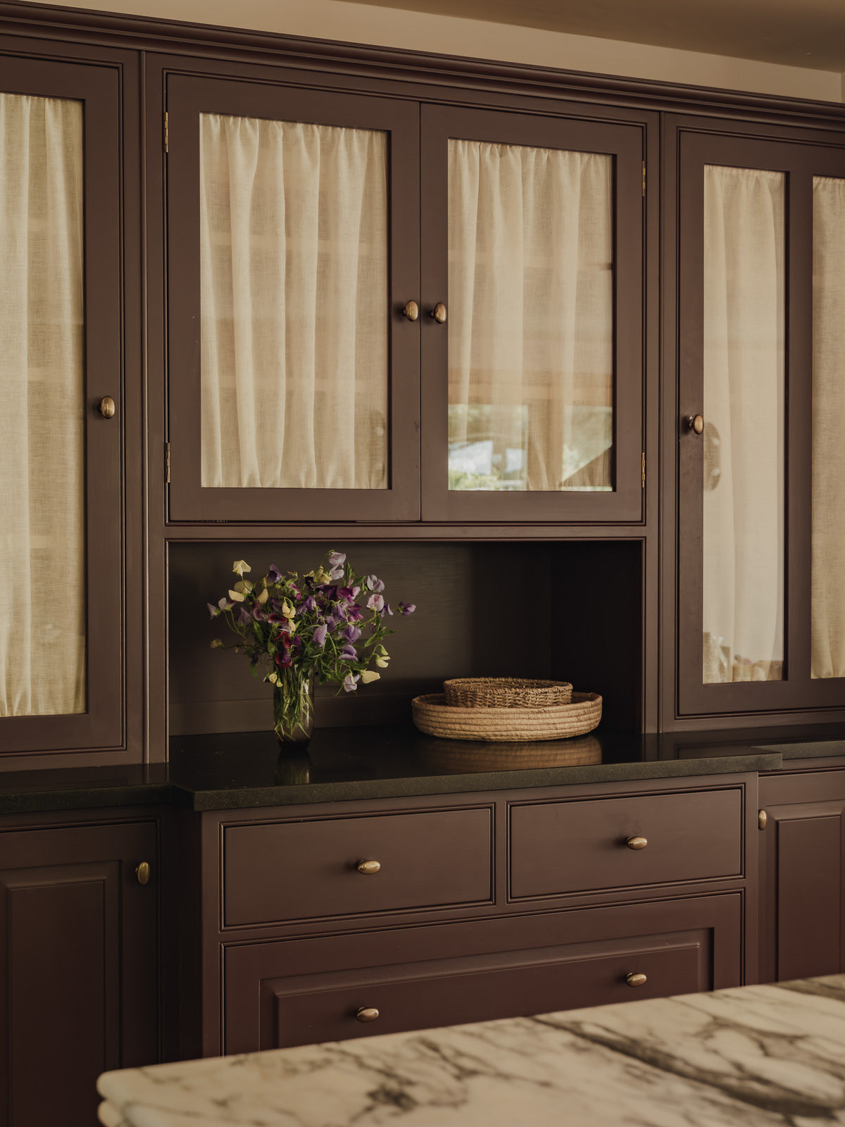 Double rod pocket café curtains in Sera linen, gathered top and bottom in the glazed doors of a pantry dresser at Baywell Studio