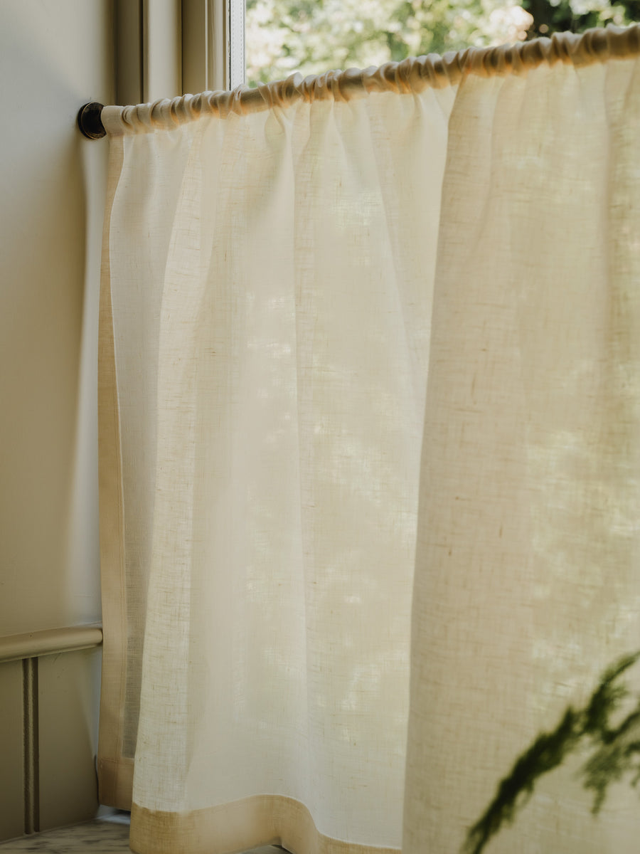 Rod pocket café curtains in cream Sera linen on a brass pole, for bathroom privacy above a roll-top bath at Baywell Studio