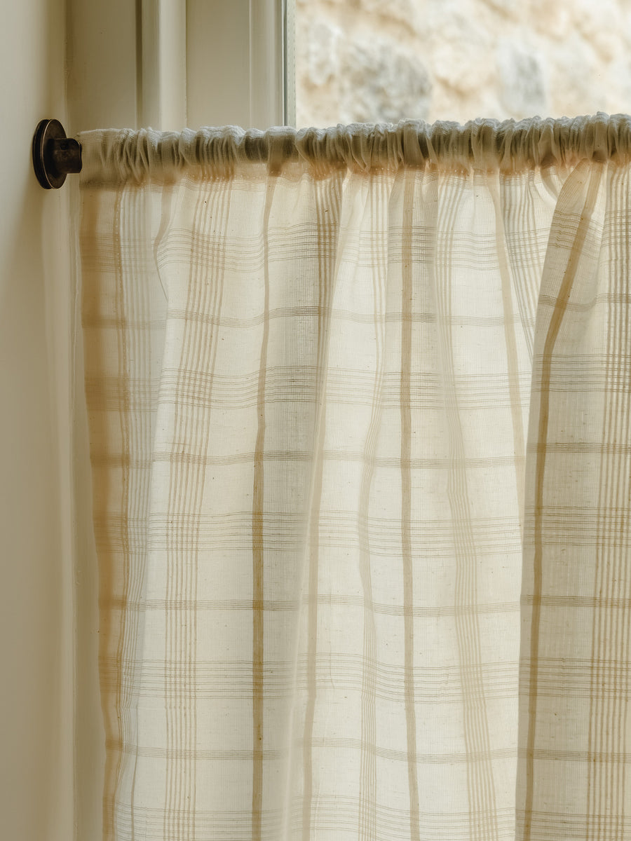 Rod pocket café curtain in Elva, an Indian cotton fine check weave, gathered on a slim brass pole at Baywell Studio