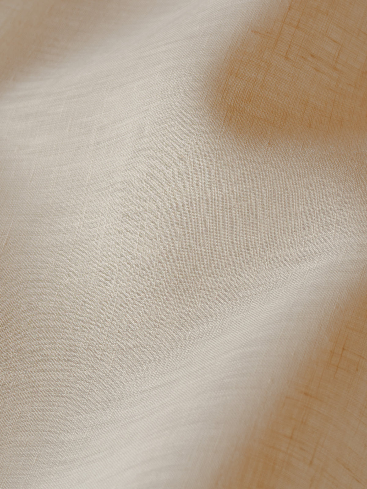 Close-up of Sera linen in cream, an exclusive café curtain fabric at Baywell Studio, showing its soft natural weave