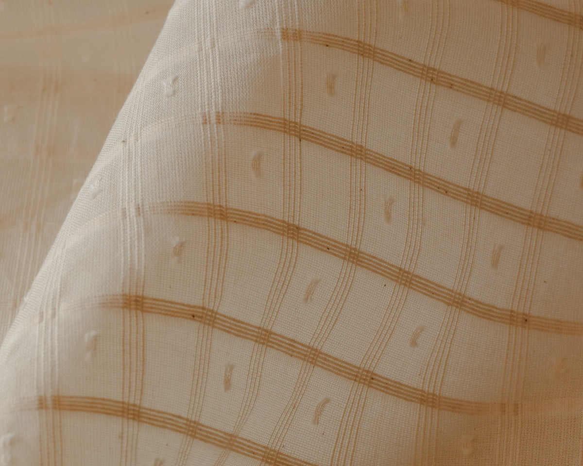Close-up of Alda cotton in a fine honey check weave with small woven dots, a café curtain fabric at Baywell Studio