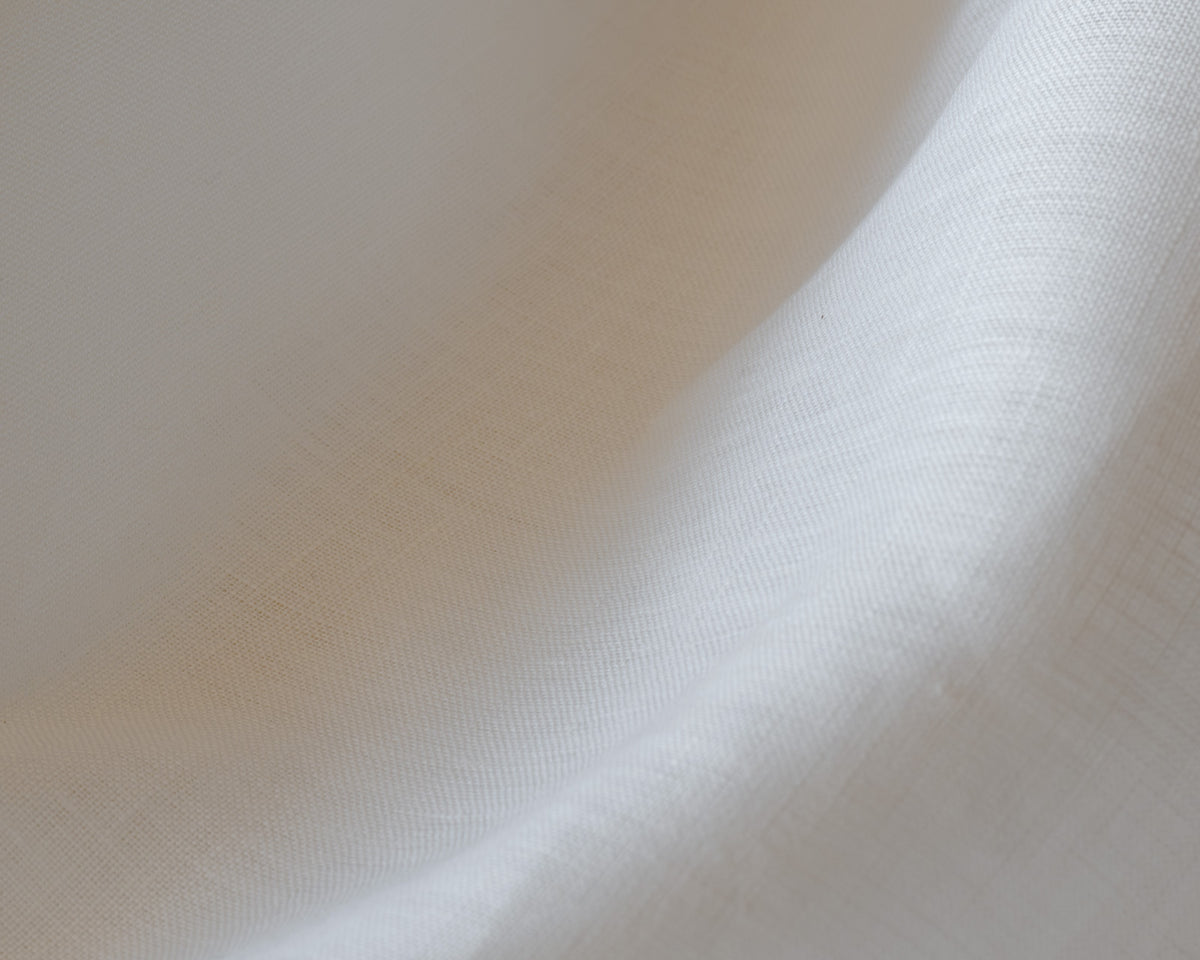 Close-up of Luma linen in white, showing its soft plain weave and gentle drape, a café curtain fabric at Baywell Studio