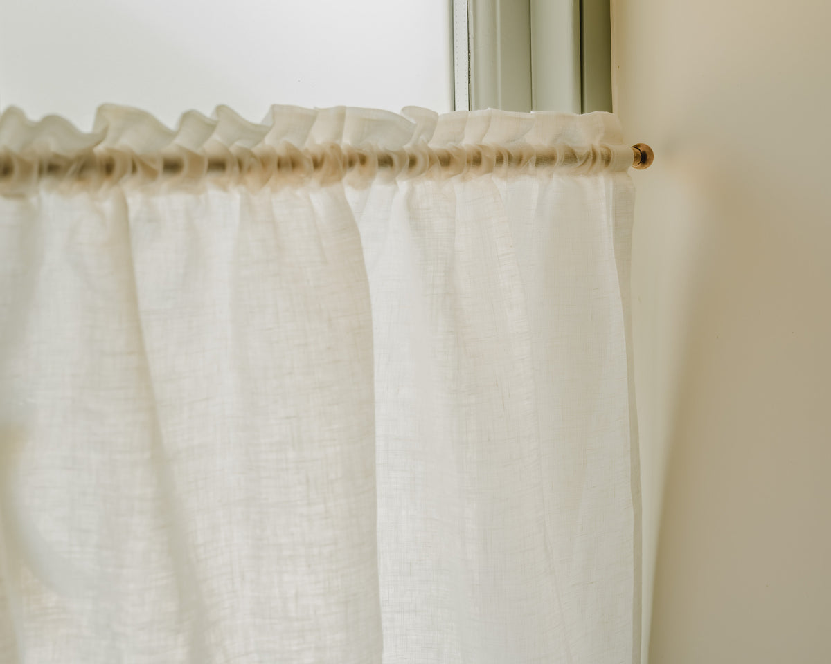 Close-up of Luma linen in white, showing its soft plain weave and gentle drape, a café curtain fabric at Baywell Studio