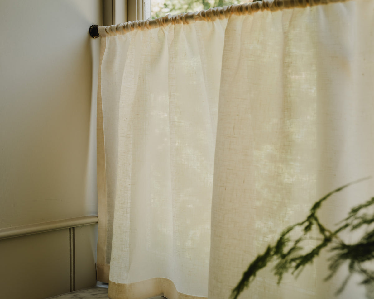Close-up of Sera linen in cream, showing its soft plain weave and gentle drape, a café curtain fabric at Baywell Studio